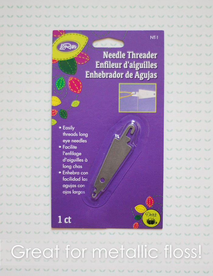 LoRan needle threader. A metal needle threader in a purple package. Text reads "Great for metallic floss".