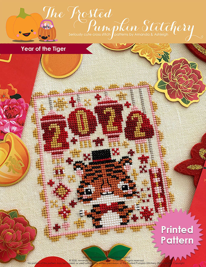 Year of the Tiger counted cross stitch pattern. A tiger wearing a top hat and sparkler with lanterns that say 2022. Printed Pattern.