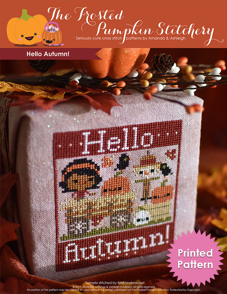 Hello Autumn counted cross stitch pattern. Brown skinned girl is on a hay ride with pumpkins and a scarecrow. Printed Pattern.
