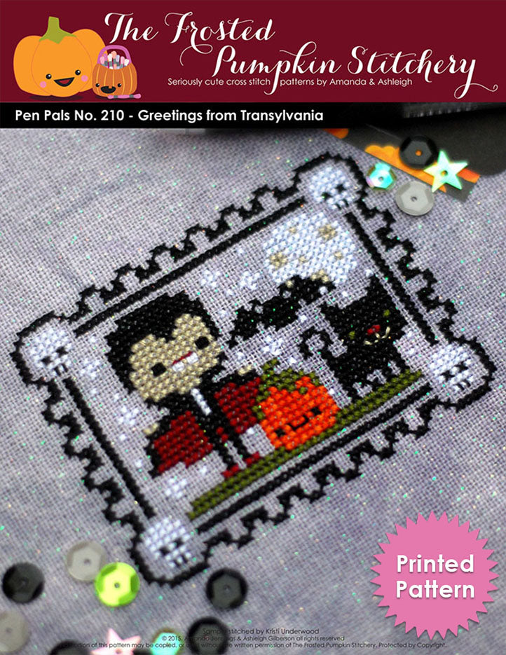 Pen Pals No 210 Halloween Greetings from Transylvania counted cross stitch pattern. Dracula stands next to a pumpkin and a black cat. Printed Pattern.