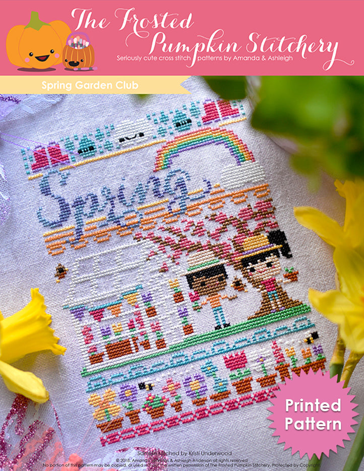 Spring Garden Club counted cross stitch pattern. A boy with dark skin and black hair and a girl with light skin and black hair are spending time outside a greenhouse. They are holding plants. The text reads "Spring". Printed Pattern.