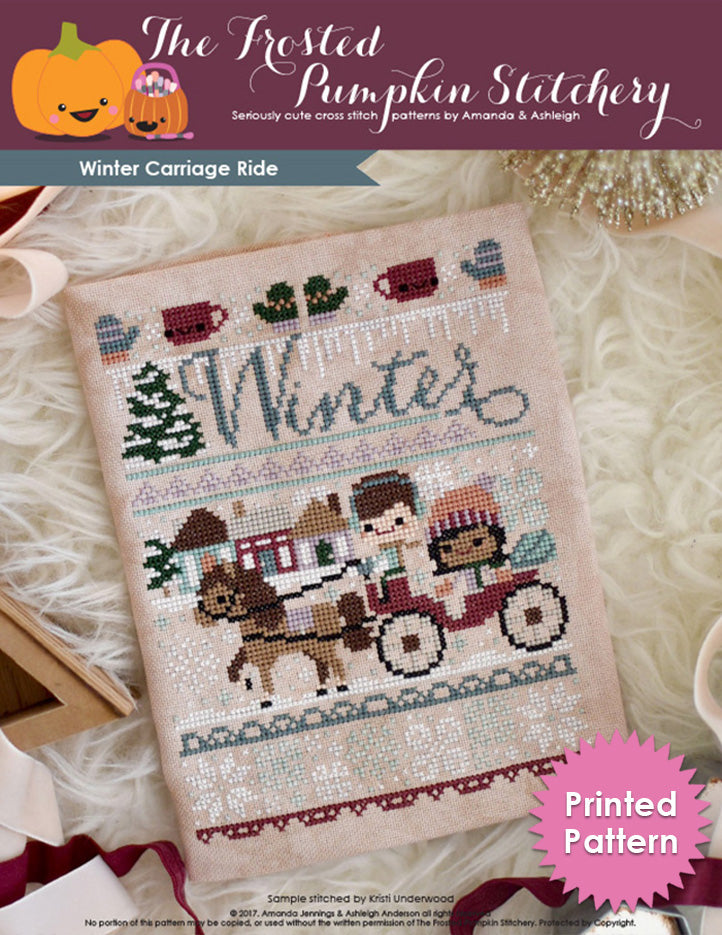 Winter Carriage Ride counted cross stitch pattern. A horse drawn carriage with a man with fair skin and medium brown hair and a woman with light brown skin and dark hair. She's wearing a peach colored hat, he's wearing ear muffs.