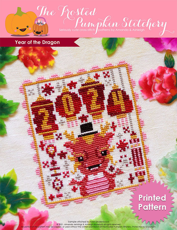 Year of the Dragon counted cross stitch pattern. A dragon wearing a top hat and holding a sparkler with lanterns that say 2024. Printed Pattern.