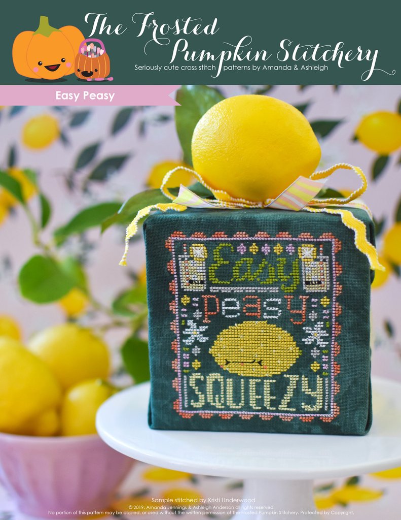Easy Peasy Counted Cross Stitch Pattern. Image of a sour faced lemon stitched on green fabric with the text Easy Peasy above the lemon and below the word Squeezy.