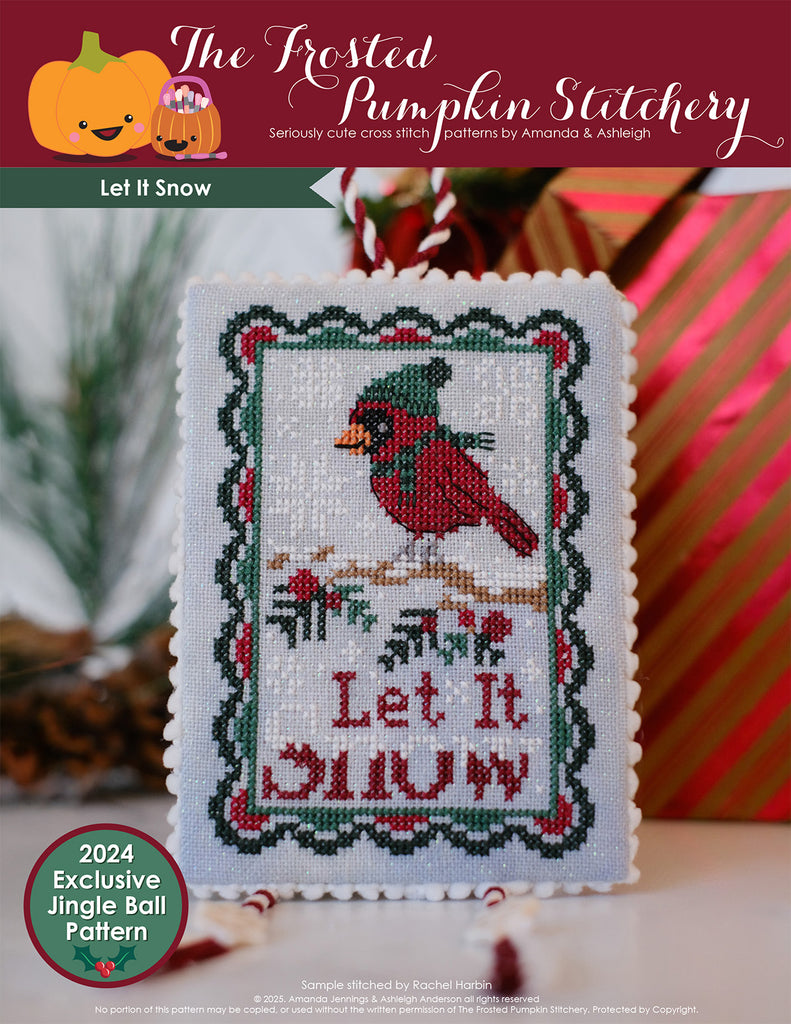 Cross stitched ornament with cardinal in a scarf and hat and 'Let It Snow' text