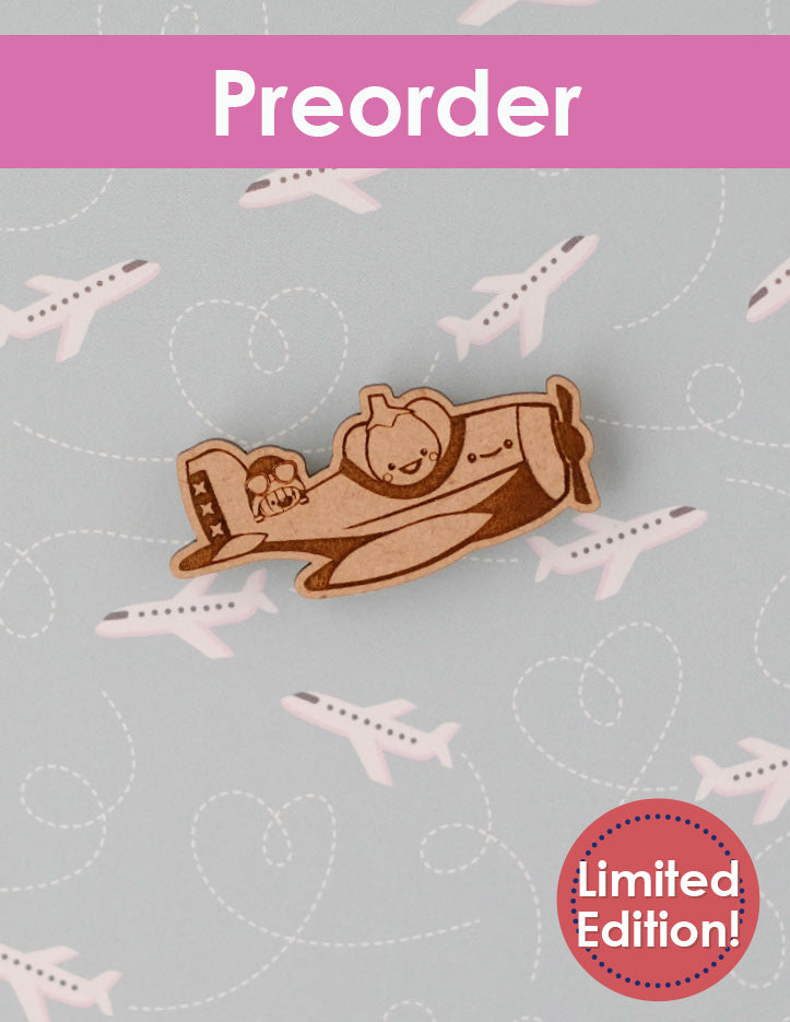 needleminder of an airplane flown by a pumpkin on a gray background with airplane illustrations, labeled 'Preorder Limited Edition'.
