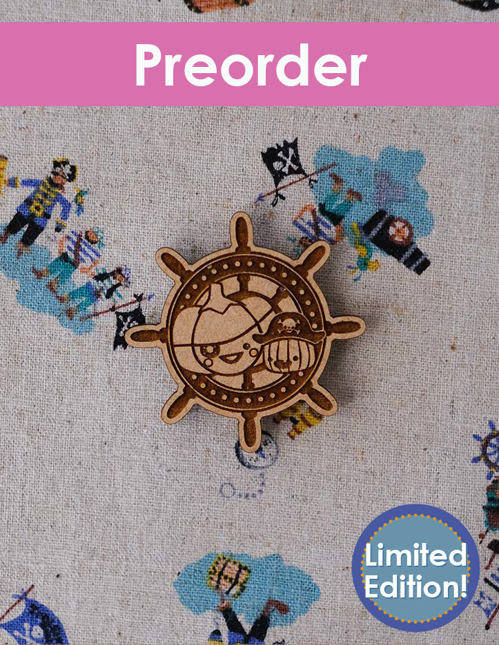 Wooden ship's wheel ornament with pirate illustrations on a textured background, labeled 'Preorder Limited Edition'.