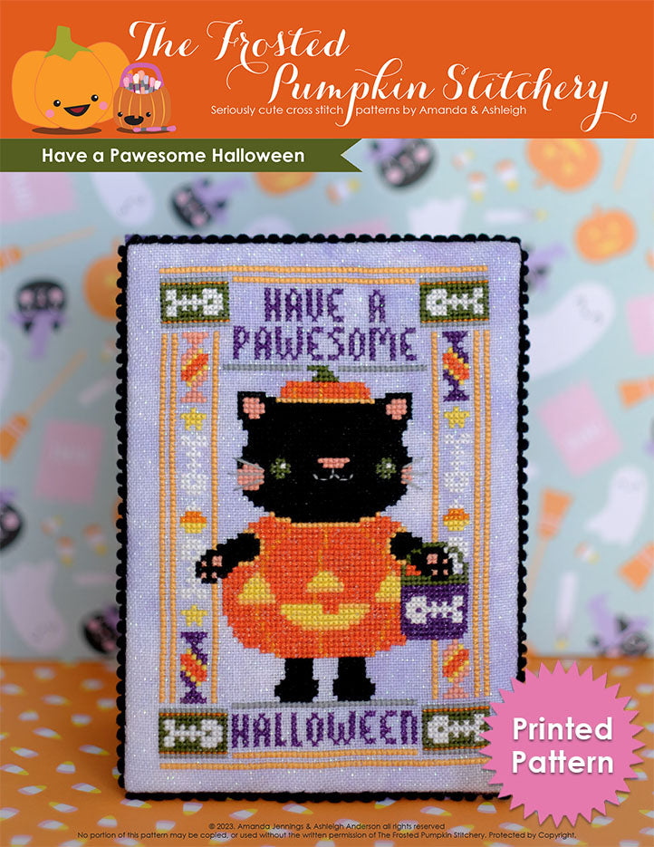 Have a Paweome Halloween! A black cat has been cross stitched on purple fabric. He is wearing a pumpkin costume and is holding a treat basket.