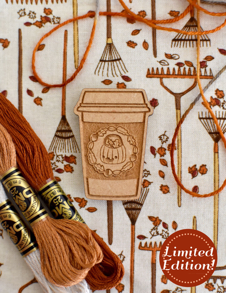 Image of a wooden needleminder with a pumpkin spice latte.