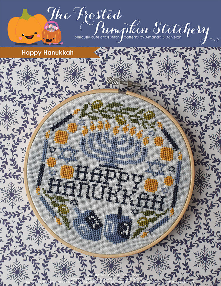 Happy Hanukkah counted cross stitch pattern. Image of a menorah surrounded by the words "Happy Hanukkah," candles, multiple Star of David, gelt, dreidels and olive branches.