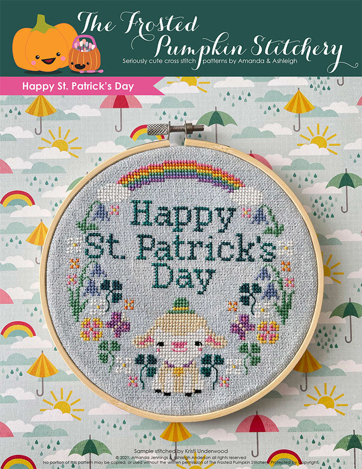 Happy St. Patrick's Day cross stitch pattern features a little lamb with a hat surrounded by spring wildflowers and a rainbow.