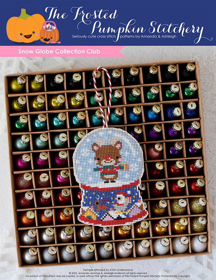 Snow Globe Collection Club Cross Stitch Pattern. The first ornament of this club features Rudolph the Reindeer holding a present while standing in a snow globe. This pattern is stitched on white perforated paper.