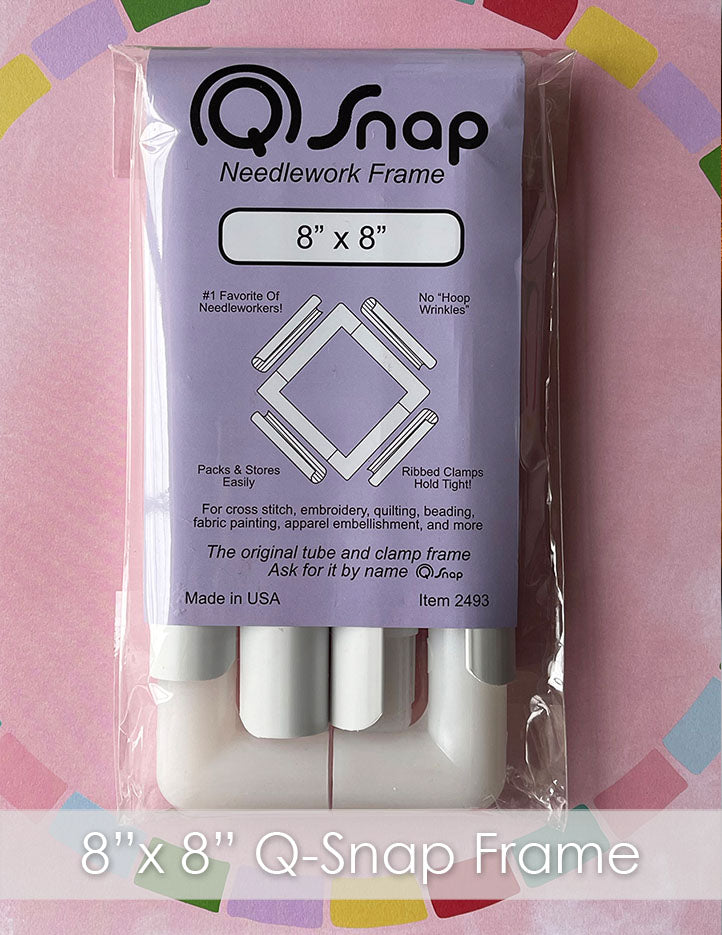 A plastic 8x8 inch qsnap frame in a purple package that reads "QSnap needlework frame" on pink paper with a rainbow heart around it.