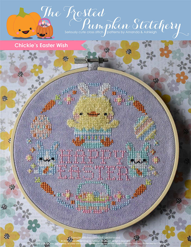Chickie's Easter Wish Cross Stitch Pattern. This pattern is finished in a 6" embroidery hoop and features a fuzzy chick hatching from an Easter egg surrounded by pastel bunnies, carrots, flowers, eggs, Easter basket and the phrase "Happy Easter."