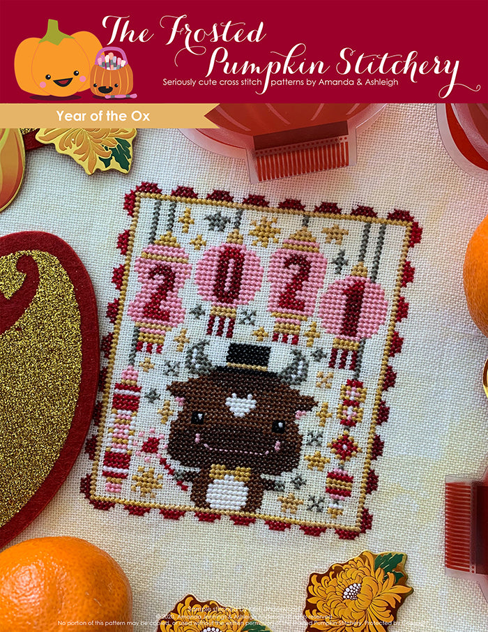 Chinese Zodiac Year of the Ox counted cross stitch pattern. An ox wearing a top hat and holding a sparkler under lanterns with the numbers 2021