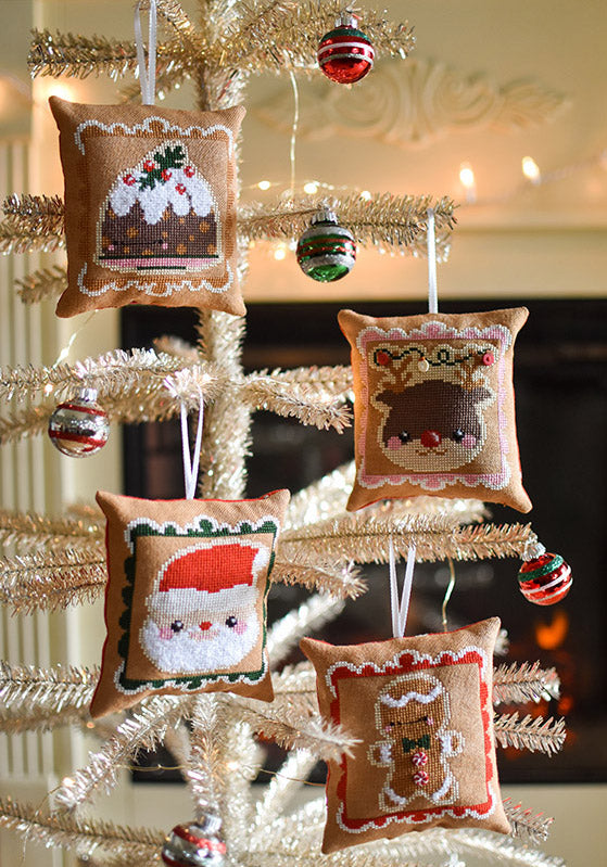 Cookies for Santa counted cross stitch pattern. Chubby ornaments are hanging on a tinsel tree.