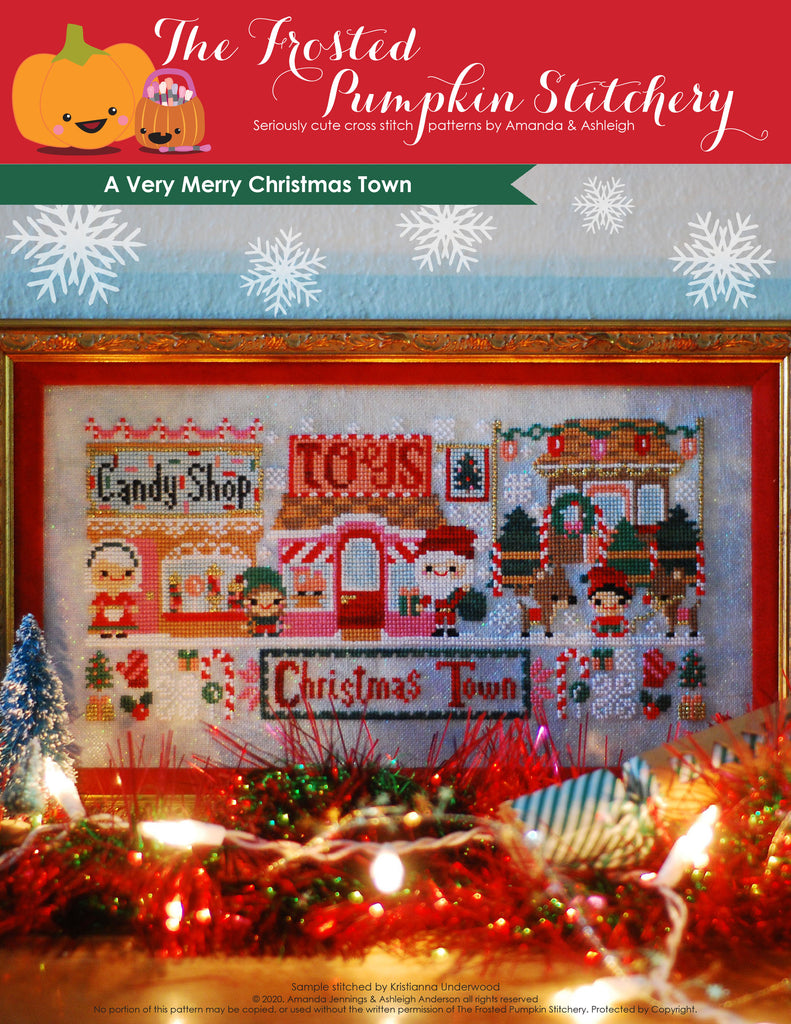 A Very Merry Christmas Town counted cross stitch pattern with a candy shop, Mrs. Claus, toy shop, Santa, reindeer and a Christmas tree lot. 