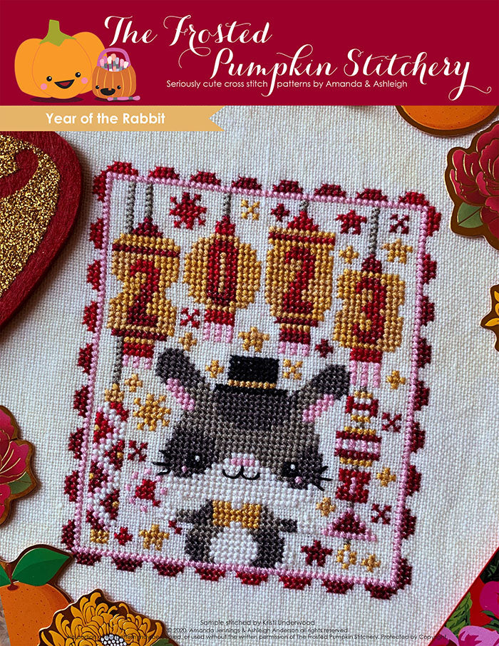 Year of the Rabbit Chinese zodiac counted cross stitch pattern features customizable year lanterns, a rabbit and a color palette of red and gold.