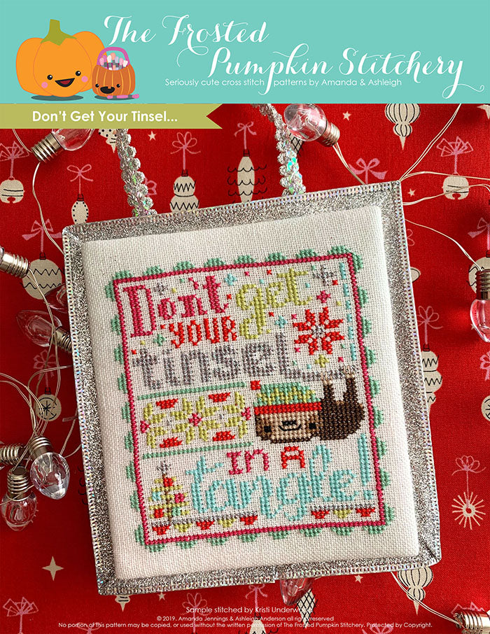 Don't Get Your Tinsel counted cross stitch pattern. Text reads "Don't get your tinsel in a tangle" with a sloth.