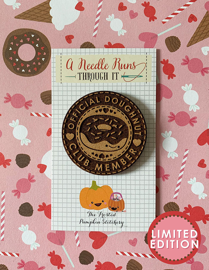 Image of a wooden needleminder with a doughnut with sprinkles. Text reads "Official Doughnut Club Member".