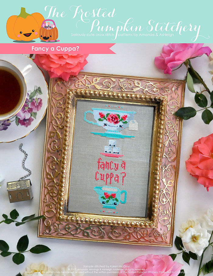 Fancy a Cuppa counted cross stitch pattern. A traditional tea cup with roses, stacked on top of sugar cubes with text that reads "fancy a cuppa".