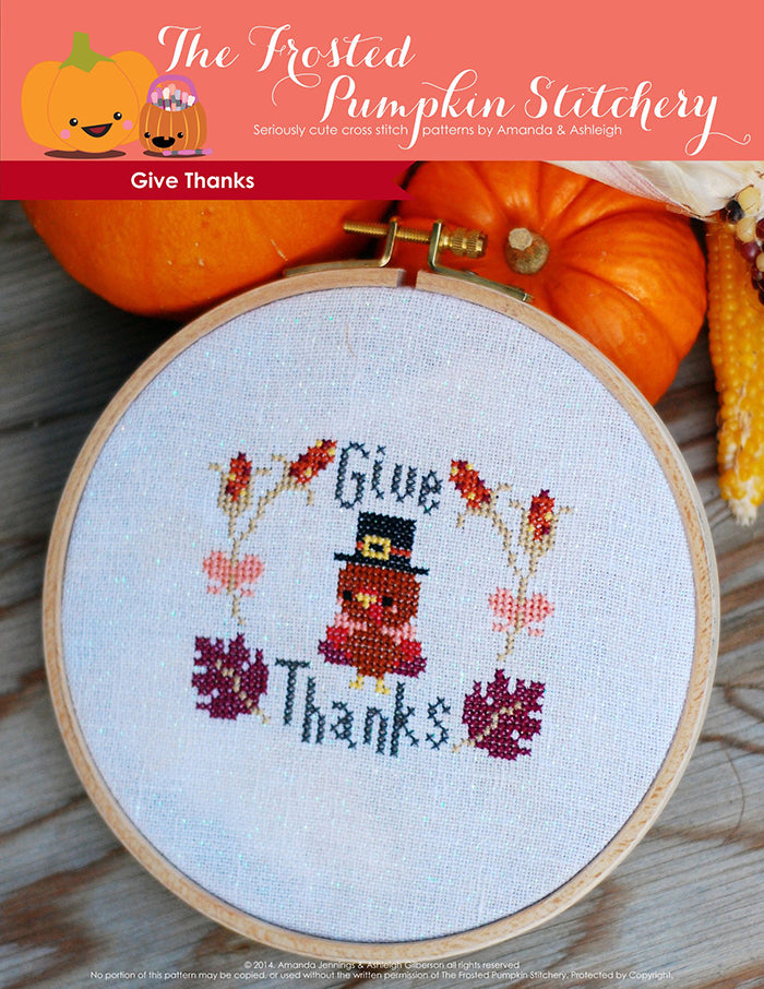 Give Thanks counted cross stitch pattern. A little Thanksgiving turkey wearing a hat surrounded by leaves and the text says "Give Thanks".