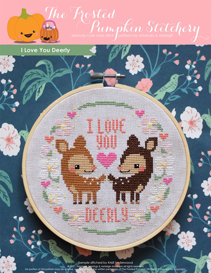 I Love You Deerly Cross Stitch Pattern. This pattern is finished in a 6" embroidery hoop and features two deer standing amongst spring blossoms,  hearts and the phrase, "I Love You Deerly."