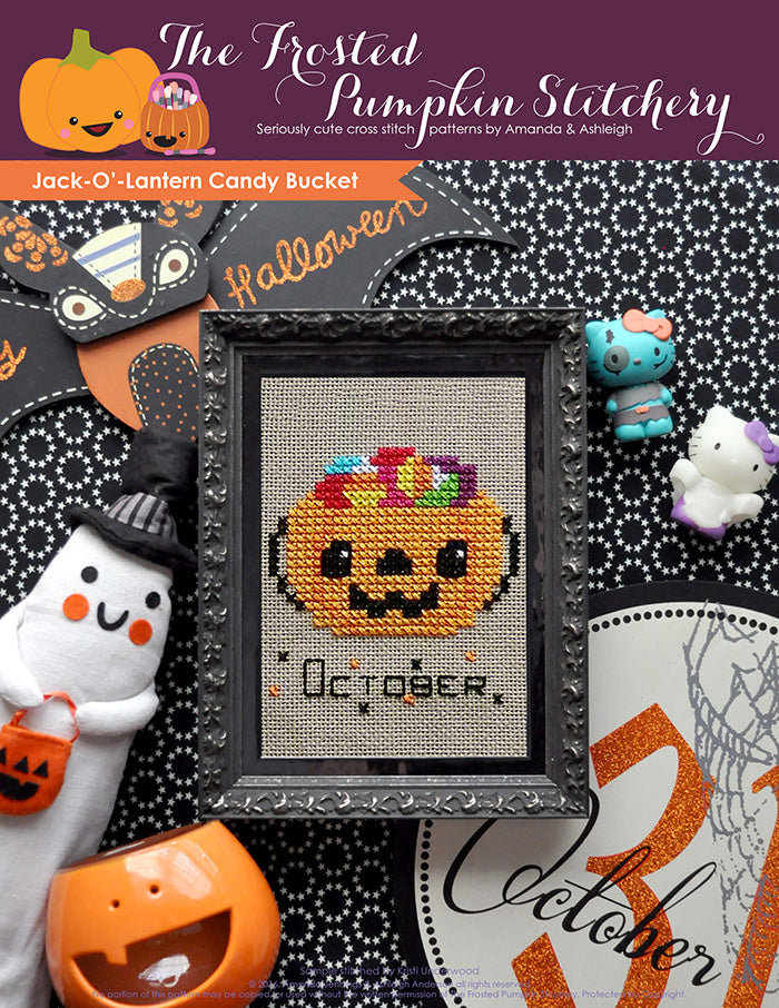 Jack'-O-Lantern Candy Bucket counted cross stitch pattern. A candy bucket filled with candy in a black frame.cross stitch pattern