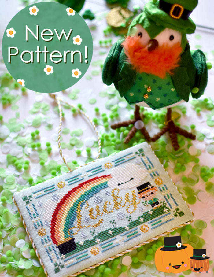 Lucky St. Patrick's Day counted cross stitch pattern. Text reads "New Pattern" and has a fake bird in the background dressed as a leprechaun. 