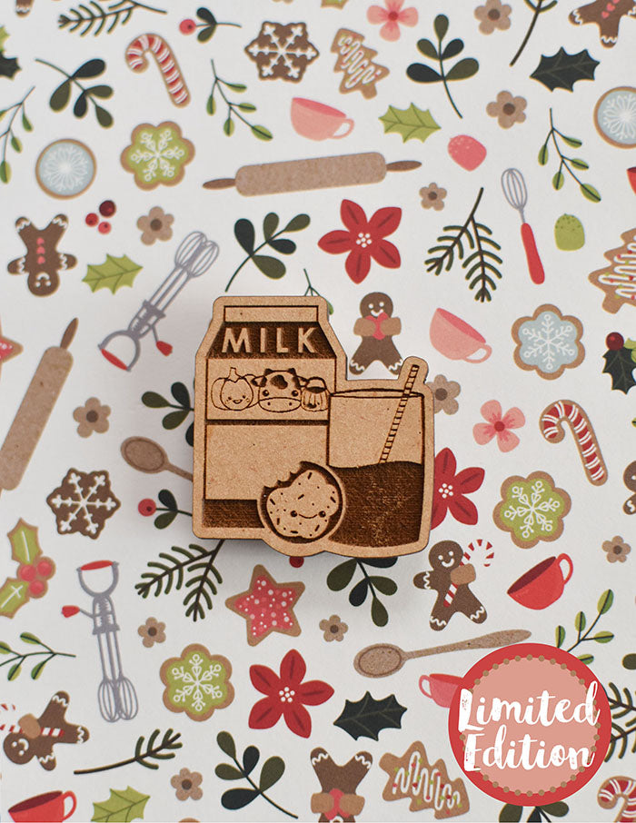 Image of a wooden needleminder with a carton of milk with a cow, a cookie and a glass of milk.