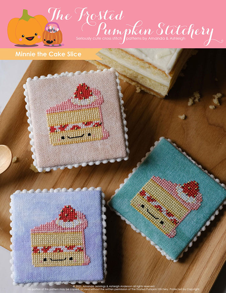 Three cream and pink colored cake slices cross stitched onto peach, purple and teal fabric are laying on a wooden tray with real cake crumbs in the background.