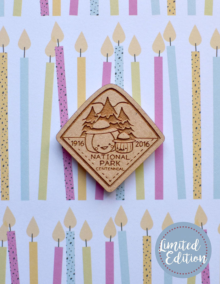 Image of a wooden needleminder with two pumpkins dressed as park rangers.