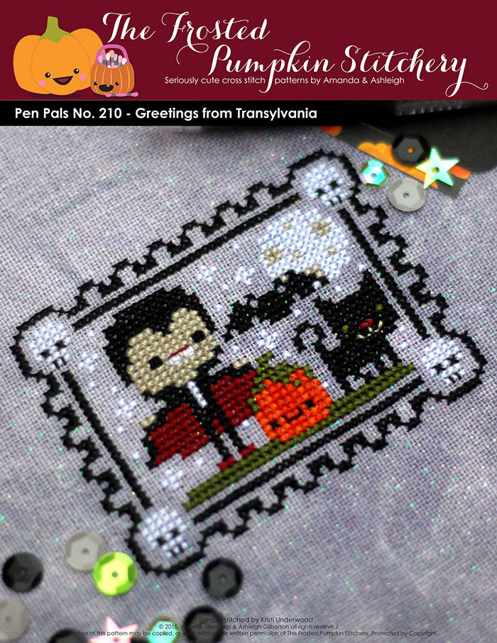 Pen Pals No 210 Halloween Greetings from Transylvania counted cross stitch pattern. Dracula stands next to a pumpkin and a black cat.