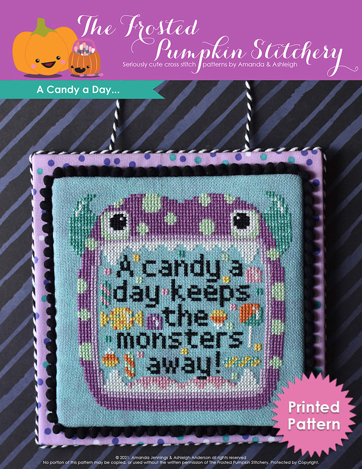 A candy a day keeps the monsters away. A purple monster with aqua horns and a pale green polka dots opens his mouth with text inside that reads "A candy a day keeps the monsters away!" Printed Pattern.