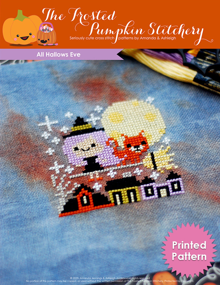 Text reads Printed Pattern. All Hallows Eve cross stitch pattern features a purple haired witch flying over a sleepy village with her favorite cat riding on her broom. In the background there is a bright moon.