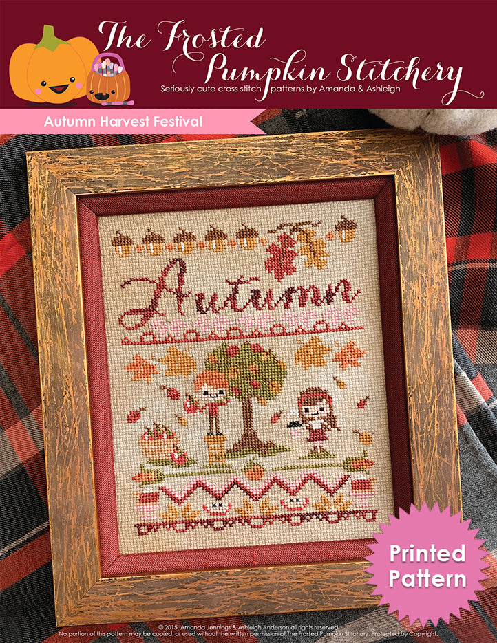 Autumn Harvest Festival fall counted cross stitch pattern. A white man with red hair and a white woman with brown hair in a burgundy headband are apple picking. He's standing on a ladder, she's holding a latte cup. The text is a hand written font that says Autumn in hand dyed thread. The border is acorns, apple slices and pie. Text reads "Printed Pattern."