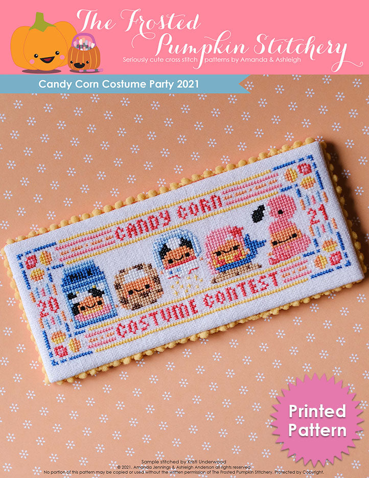 Image of Candy Corn Costume Party 2021 counted cross stitch pattern. Five little candy corns are in costumes. From left to right they are dressed as a carton of milk, a cookie, an astronaut, a mermaid and a flamingo.
