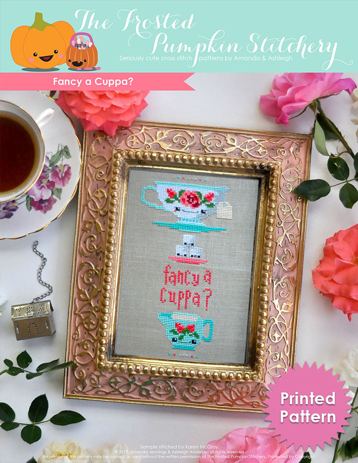 Fancy a Cuppa counted cross stitch pattern. A traditional tea cup with roses, stacked on top of sugar cubes with text that reads "fancy a cuppa". Printed Pattern.