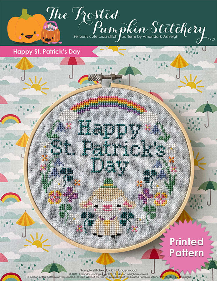 Happy St. Patrick's Day cross stitch pattern features a little lamb with a hat surrounded by spring wildflowers and a rainbow.