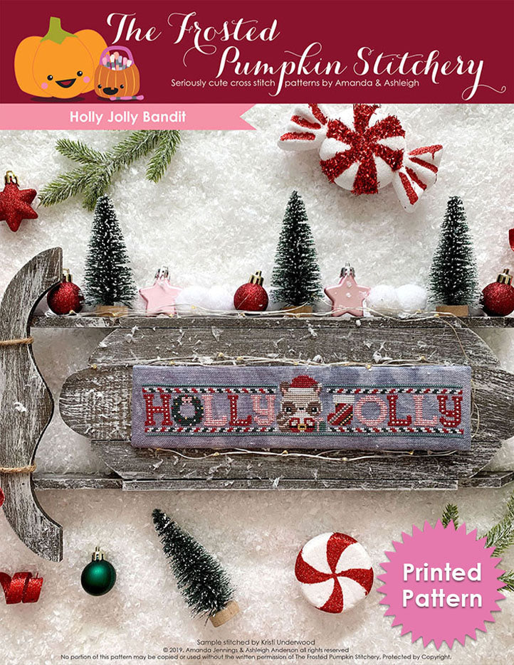 Holly Jolly Bandit counted cross stitch pattern. A raccoon wearing a santa hat stands between the words Holly and Jolly. Printed Pattern.