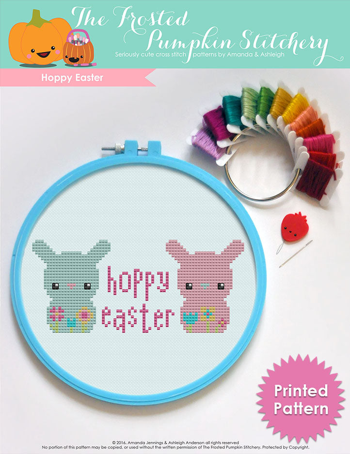 Hoppy Easter counted cross stitch pattern. Two bunnies with the text "Hoppy Easter" in between them. Printed Pattern.