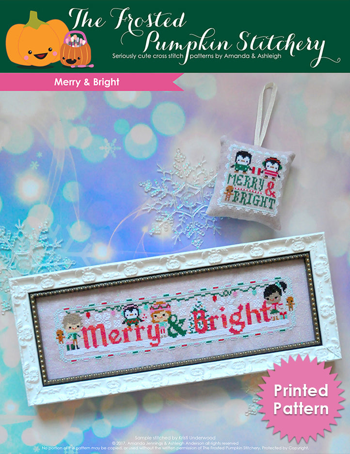 Merry and Bright counted cross stitch pattern. Three friends are decorating for the holidays with some penguins. One piece is in a white frame and the other is a scissor fob.