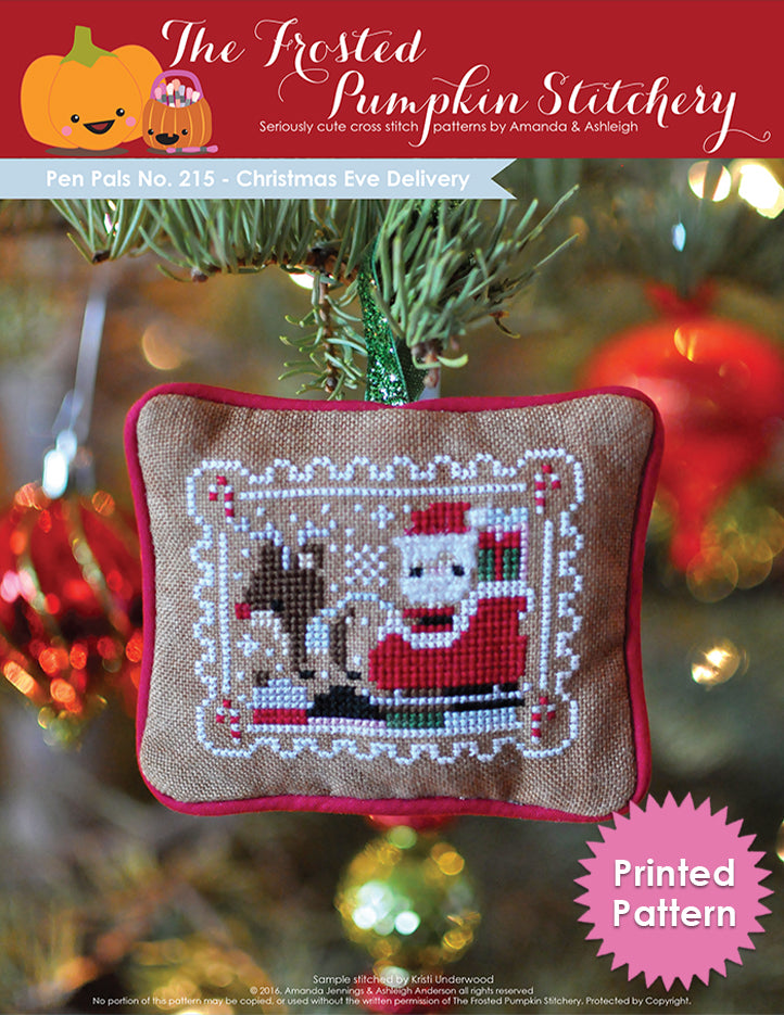 Pen Pals No 215 Christmas Eve Delivery counted cross stitch pattern. Santa and Rudolph fly over a village on Christmas Eve.