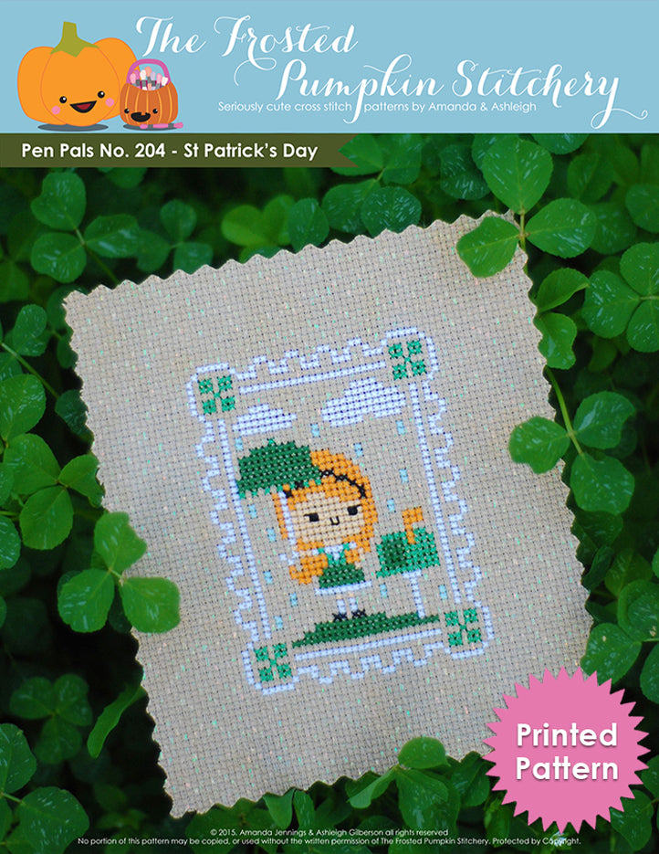 Pen Pals No 204 St Patrick's Day counted cross stitch pattern. A pale girl with red hair stands under a green umbrella next to a mailbox. Printed Pattern.