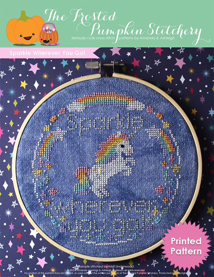 Sparkle Wherever You Go! A Unicorn with a rainbow mane and tail stands on his hind legs surrounded by rainbows and stars. Stitched on blue fabric. Printed Pattern