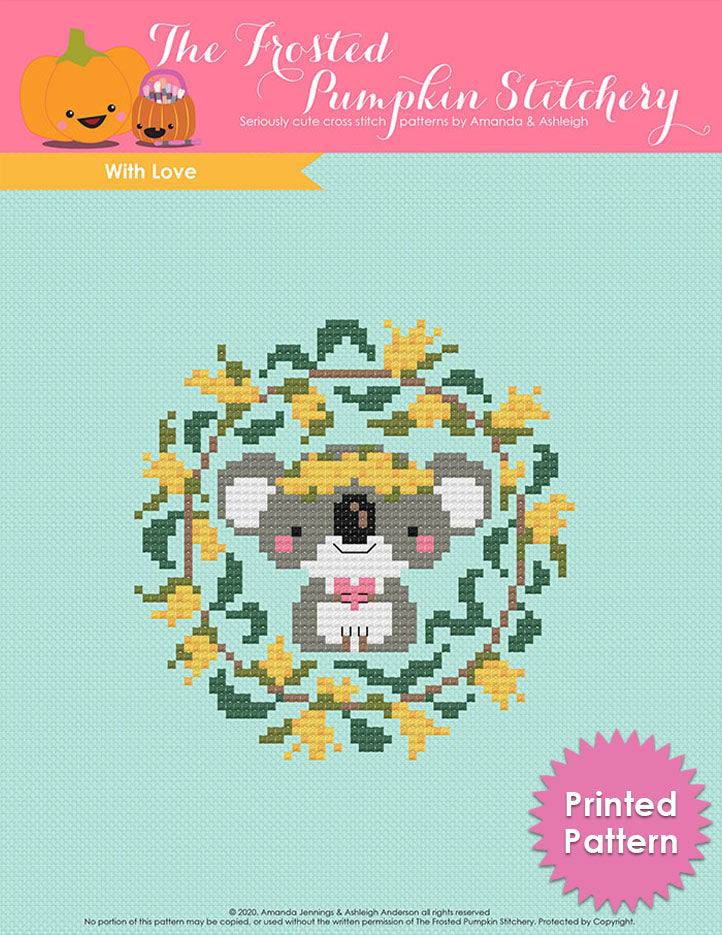 With Love counted cross stitch pattern. A koala holds a heart and is surrounded by golden wattle. Printed Pattern.