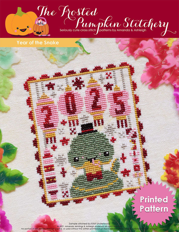 Year of the Snake counted cross stitch pattern. A snake wearing a top hat with lanterns hanging above that say 2025. Printed Pattern