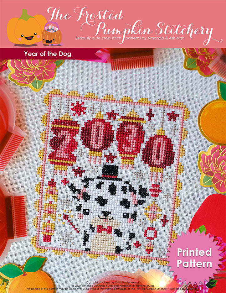 Year of the Dog counted cross stitch pattern. Features a Dalmatian wearing a top hat and holding a sparkler with lanterns that say 2030. Printed pattern.