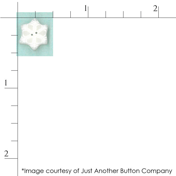 Tiny Snowflake button from Just Another Button company for scale against a ruler.
