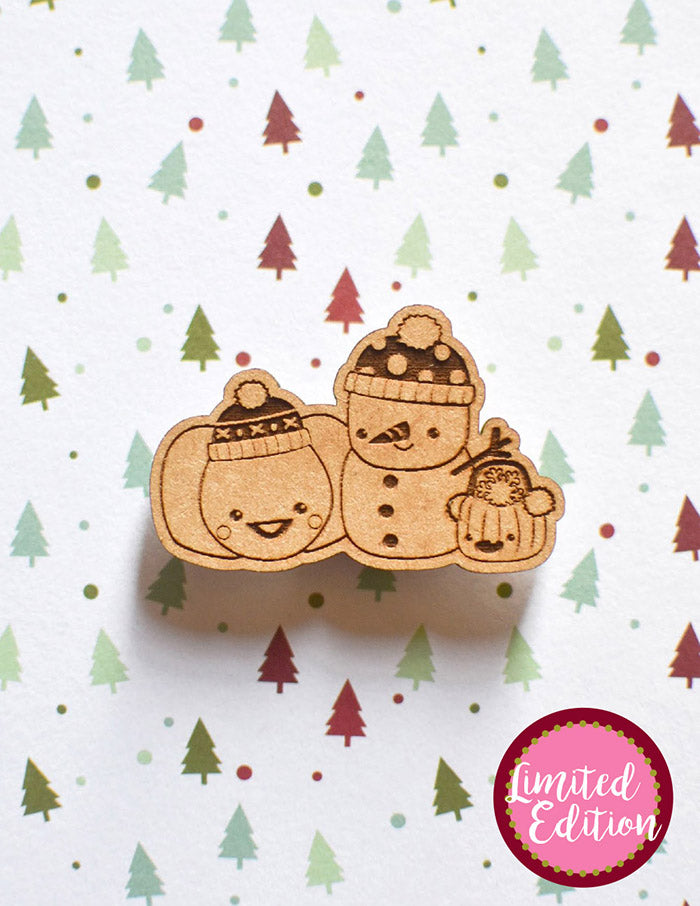 Image of a wooden needleminder with two pumpkins and a snowman wearing a polka dot hat.